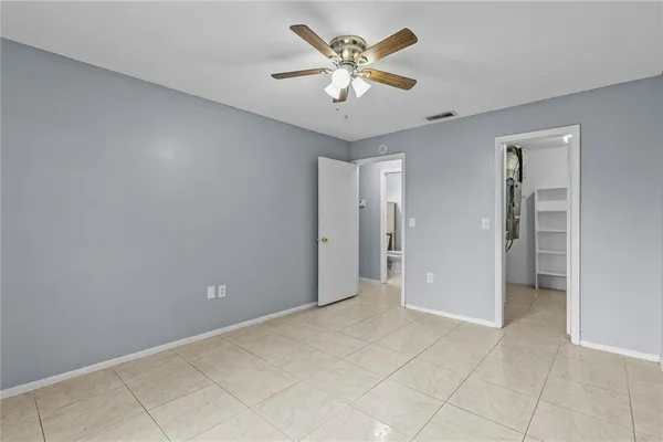 a view of an empty room with a ceiling fan