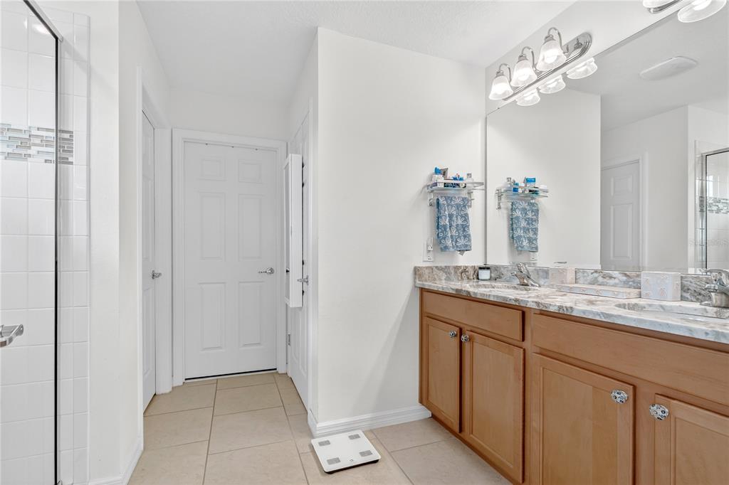2899 Parkfield Road St. Cloud, FL 34772 - Photo 20 of 52 a bathroom with a double vanity sink and a mirror