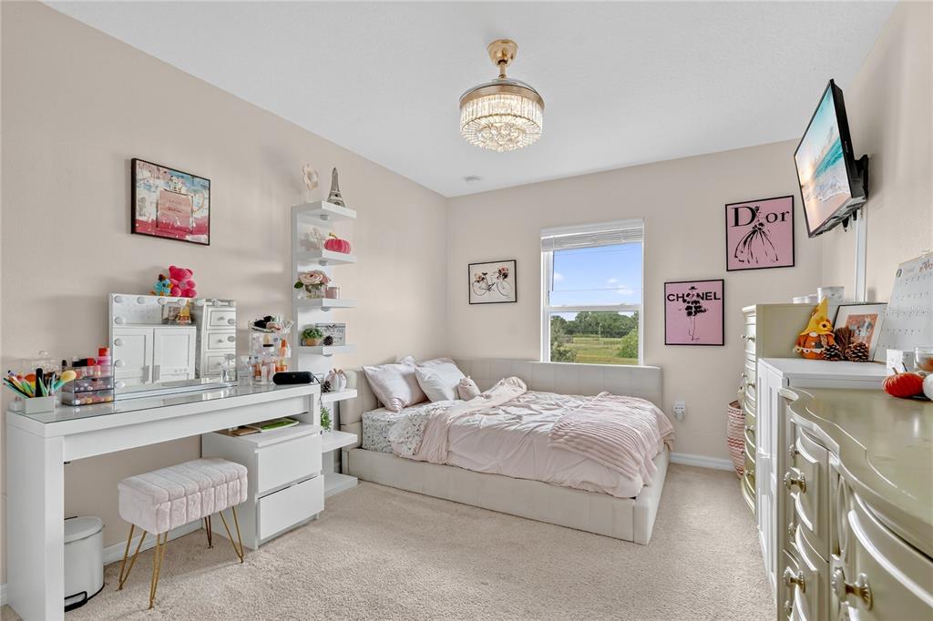 2899 Parkfield Road St. Cloud, FL 34772 - Photo 21 of 52 a bedroom with furniture and a chandelier