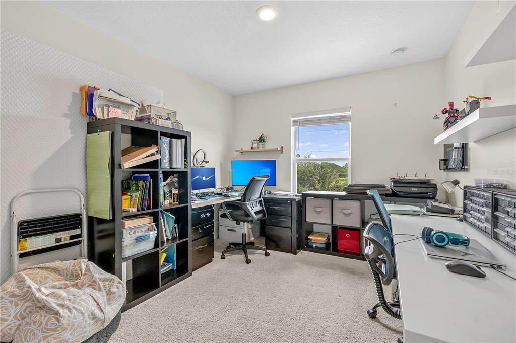 2899 Parkfield Road St. Cloud, FL 34772 - Photo 25 of 52 a view of a workspace with furniture and toys