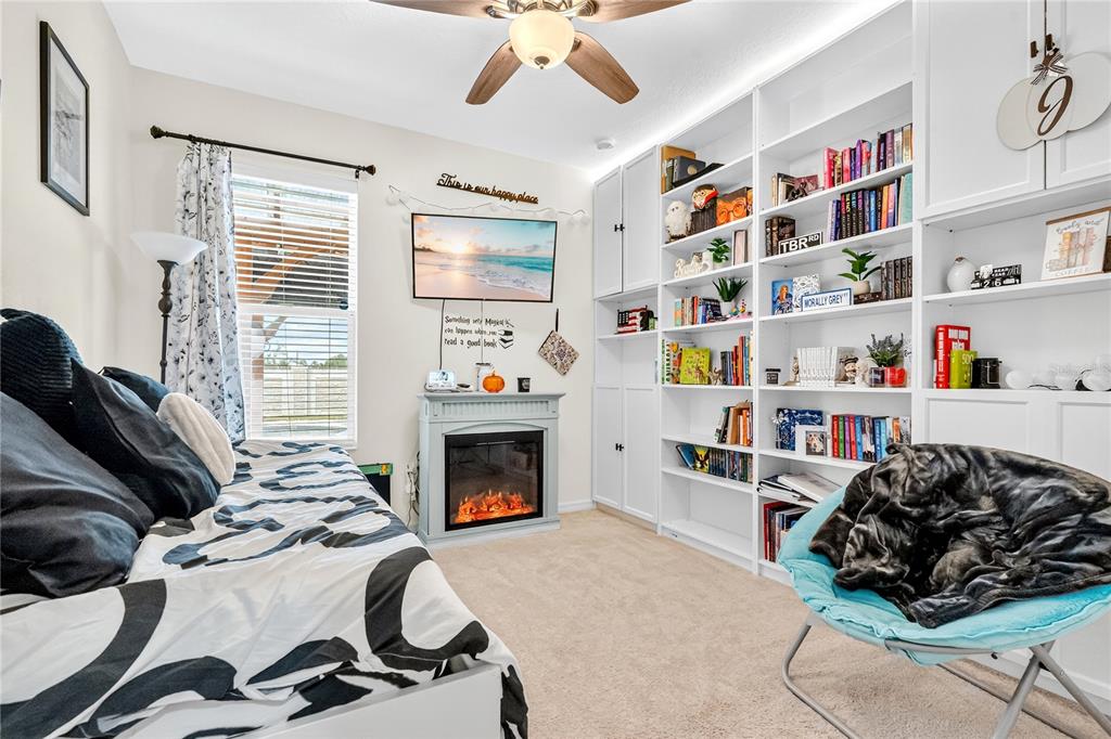 2899 Parkfield Road St. Cloud, FL 34772 - Photo 27 of 52 a bedroom with a bed and a book shelf