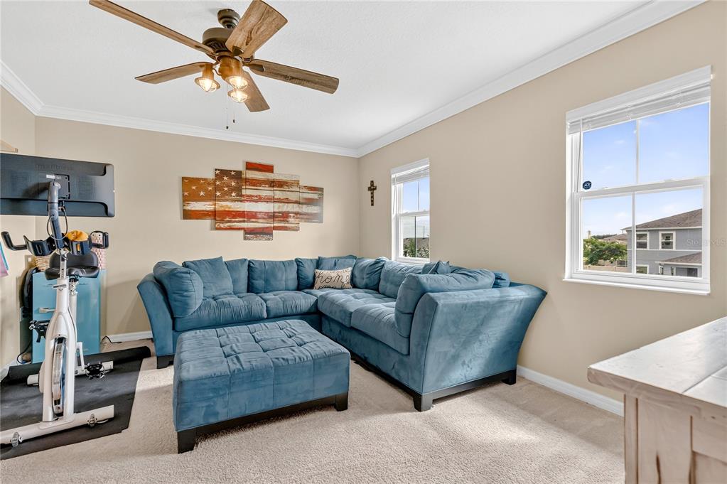 2899 Parkfield Road St. Cloud, FL 34772 - Photo 28 of 52 a living room with furniture a ceiling fan and a window