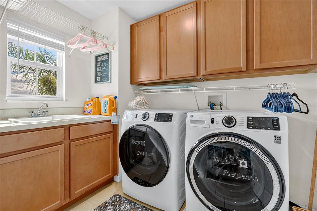 2899 Parkfield Road St. Cloud, FL 34772 - Photo 30 of 52 a utility room with sink dryer and washer