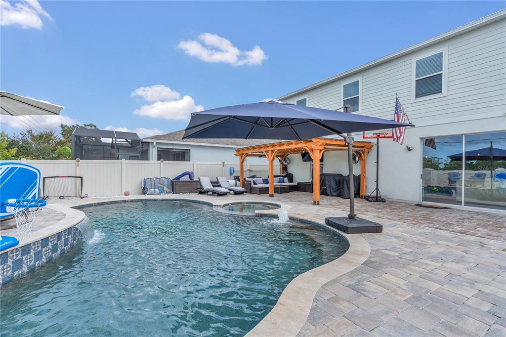 2899 Parkfield Road St. Cloud, FL 34772 - Photo 31 of 52 a view of a backyard with table and chairs under an umbrella