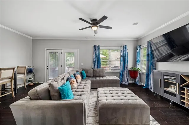 a living room with furniture a flat screen tv and a window