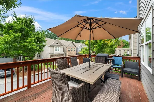 a view of balcony with furniture and umbrella