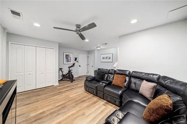 a living room with furniture and wooden floor