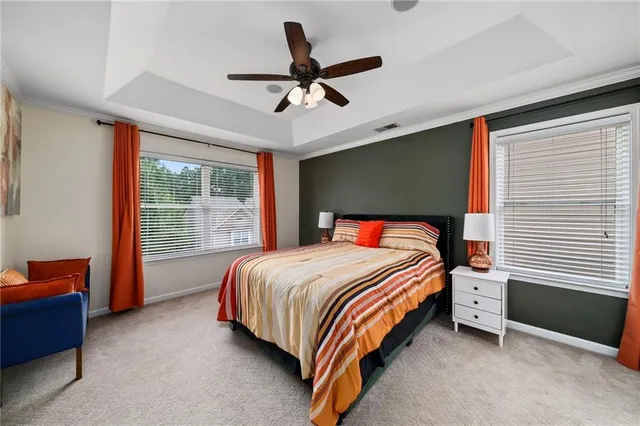 a bedroom with a bed and a ceiling fan