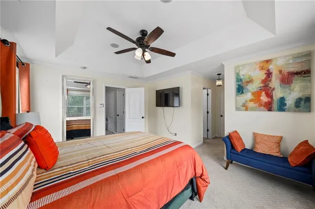 a bedroom with furniture and a large window