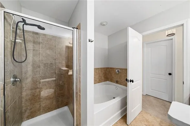 a bathroom with a shower and bathtub