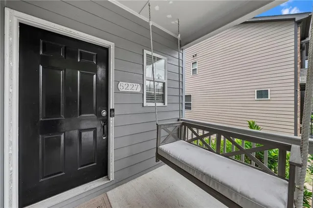 a view of a wooden bench in the porch
