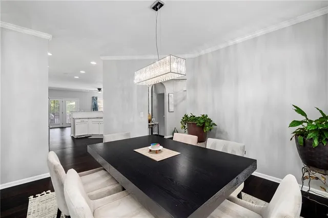 a view of a dining room with a table and chairs