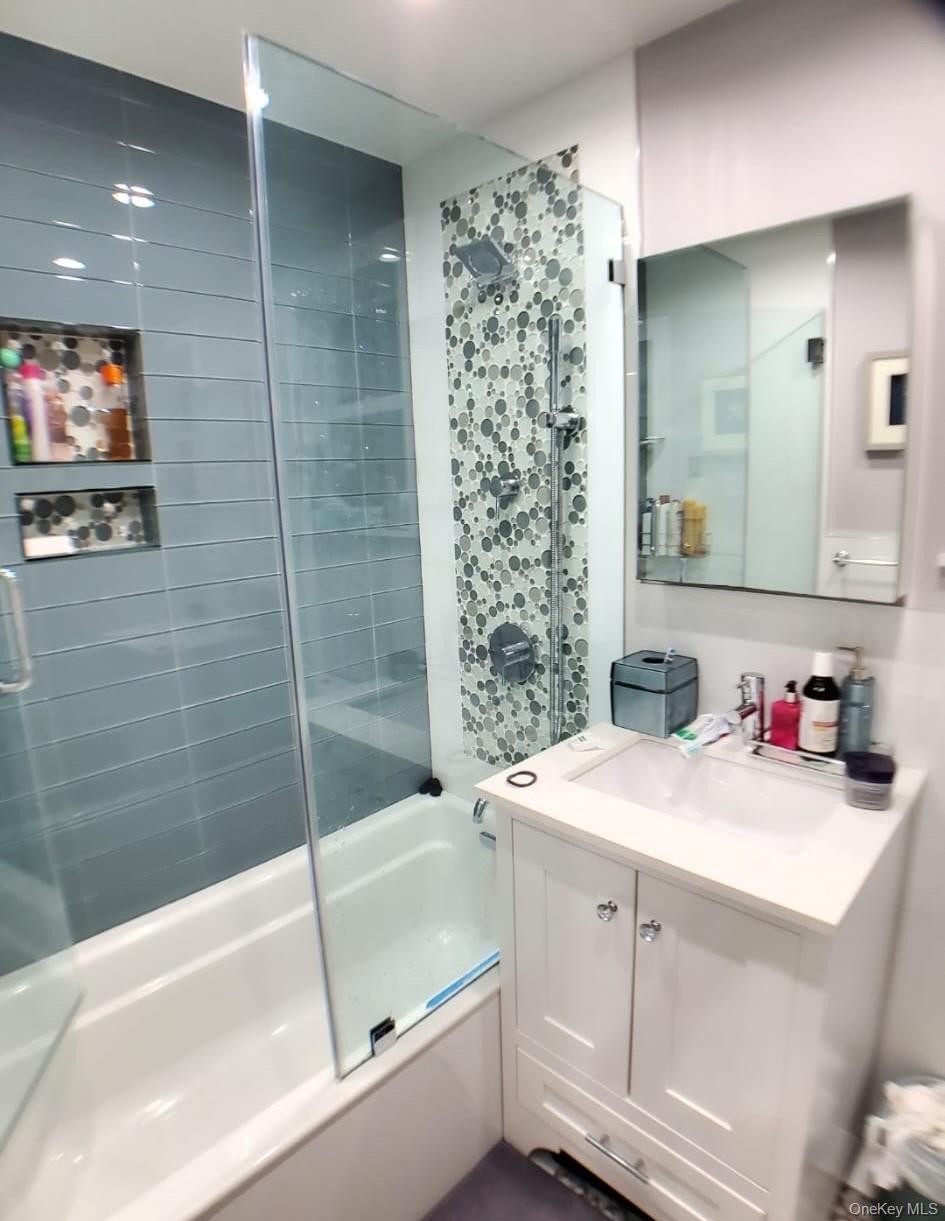 27-15 Butler Street Queens, NY 11369 - Photo 13 of 18 a bathroom with a sink a toilet and shower