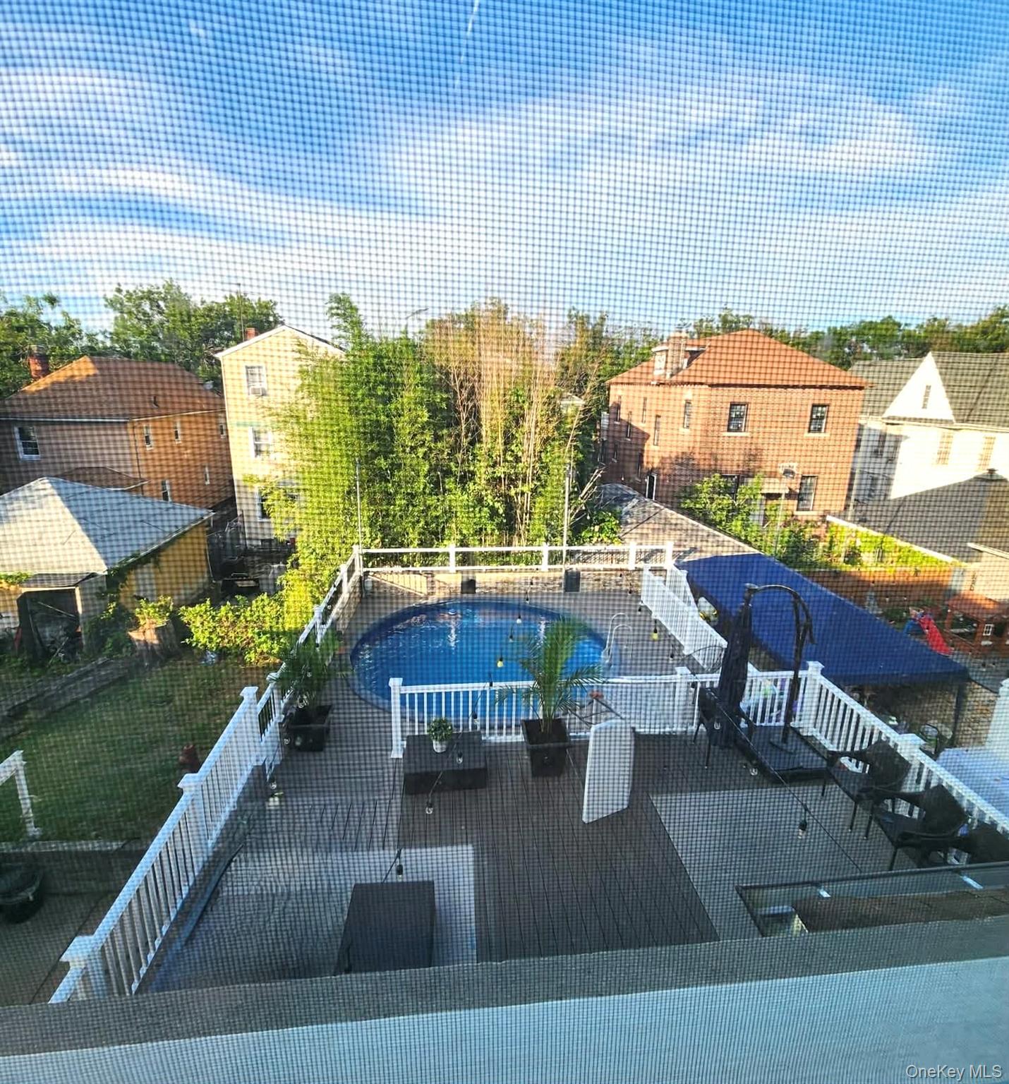 27-15 Butler Street Queens, NY 11369 - Photo 14 of 18 a view of a swimming pool with outdoor seating and plants