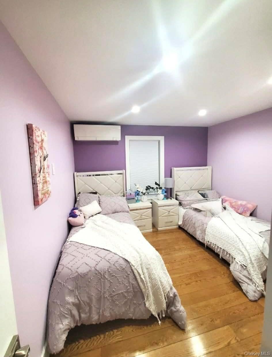 27-15 Butler Street Queens, NY 11369 - Photo 5 of 18 a spacious bedroom with a bed and window