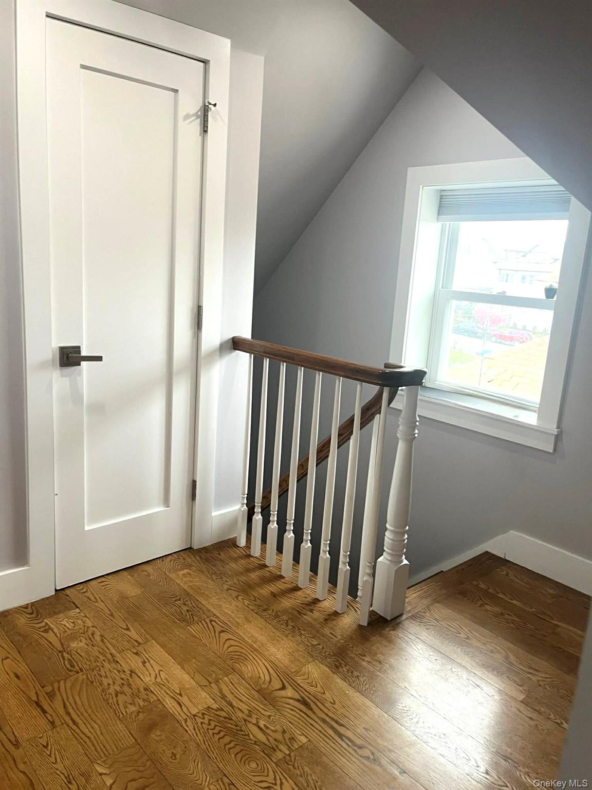 27-15 Butler Street Queens, NY 11369 - Photo 6 of 18 a view of a room with wooden floor and a window