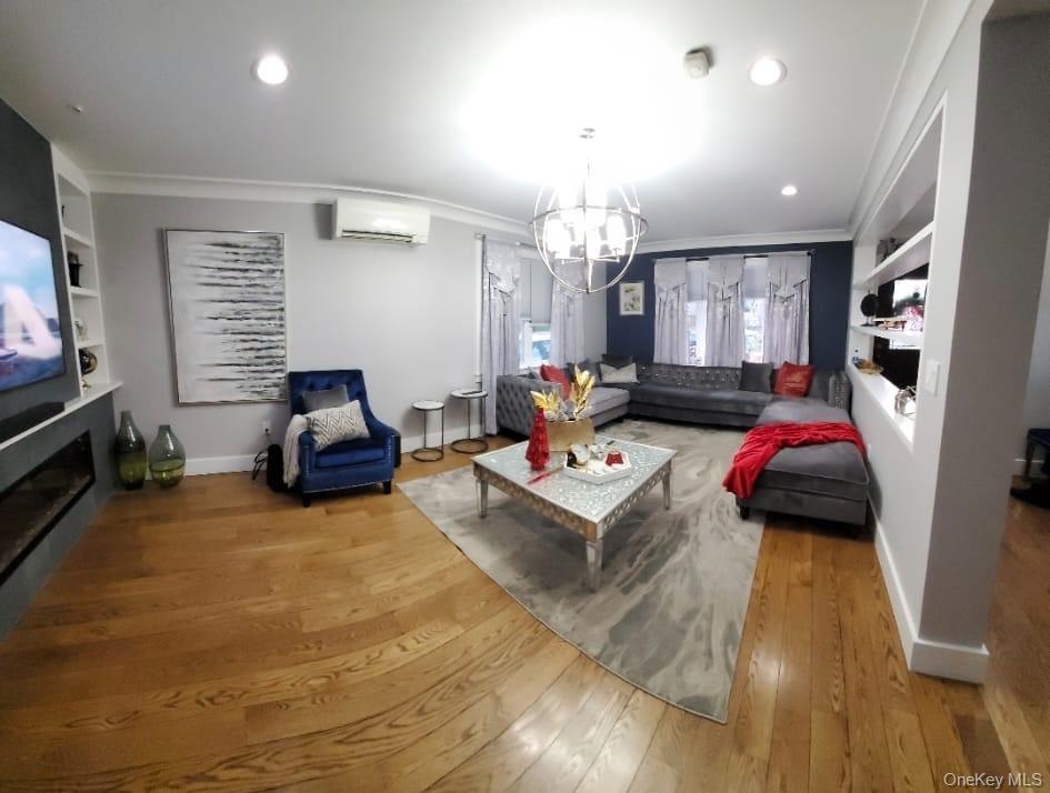 27-15 Butler Street Queens, NY 11369 - Photo 7 of 18 a living room with furniture and a chandelier