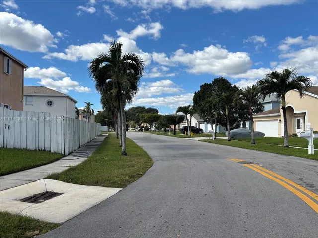 a view of a street with a building in the background