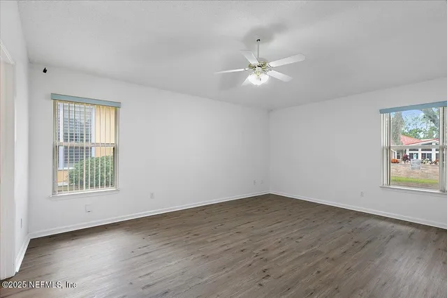wooden floor in an empty room with a window