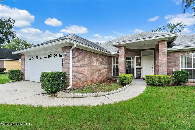 a front view of a house with a yard and garage