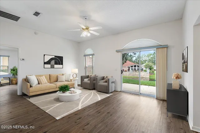 a living room with furniture and a large window