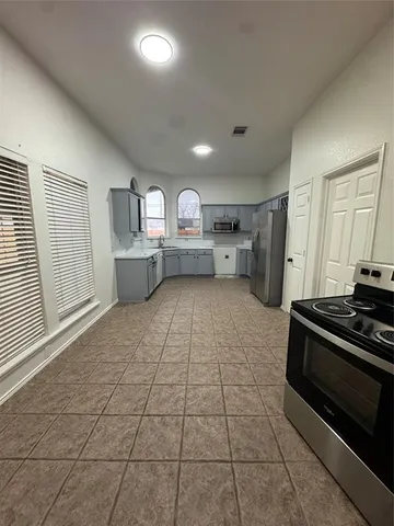 a kitchen with sink cabinets and window