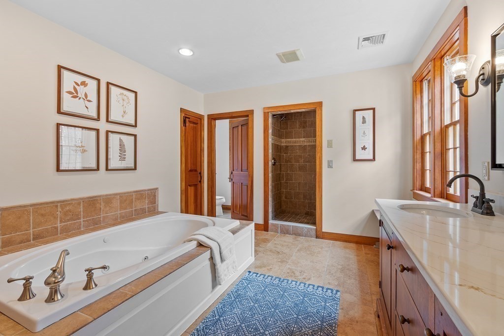24 Rocky Dundee Road Bolton, MA 01740 - Photo 16 of 35 a bathroom with a tub sink and mirror