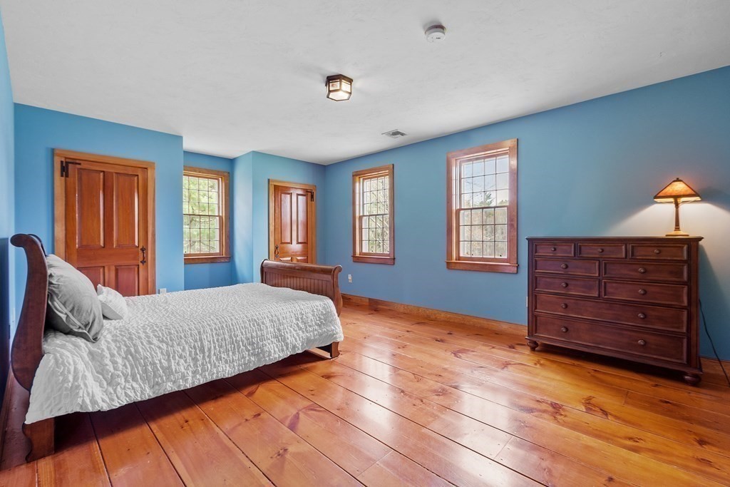 24 Rocky Dundee Road Bolton, MA 01740 - Photo 21 of 35 a bedroom with a bed and wooden floor