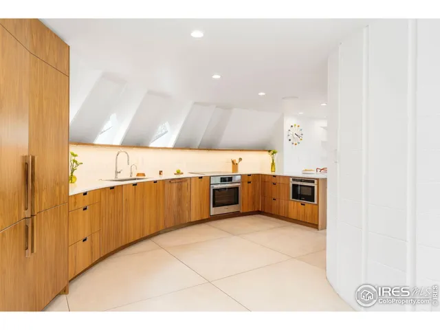 a kitchen with stainless steel appliances a sink and a refrigerator