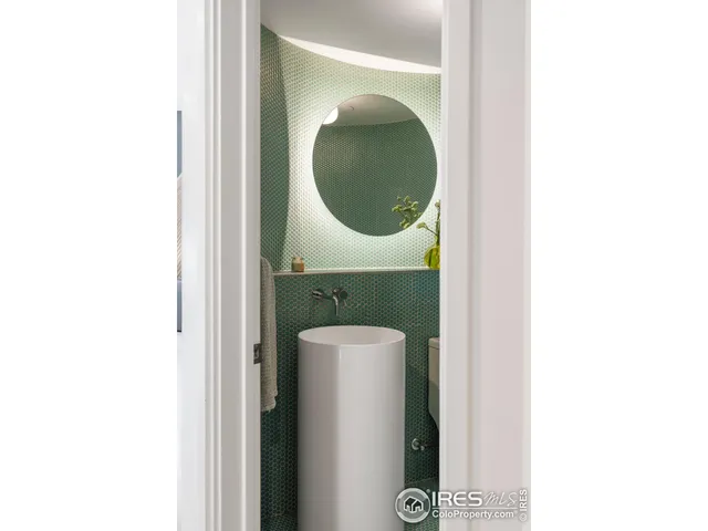 a bathroom with a toilet and a mirror