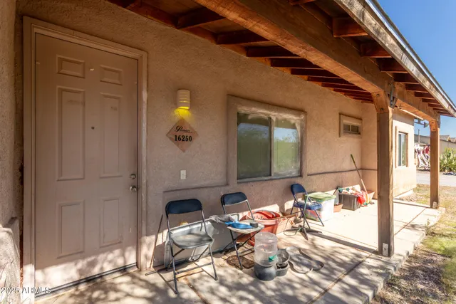 a backyard of a house with outdoor seating