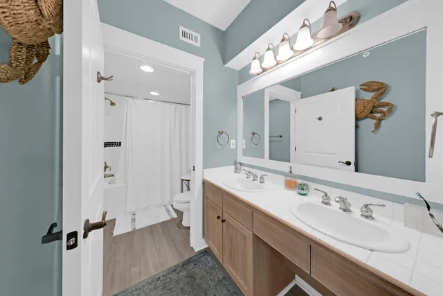 a spacious bathroom with a double vanity sink mirror and double