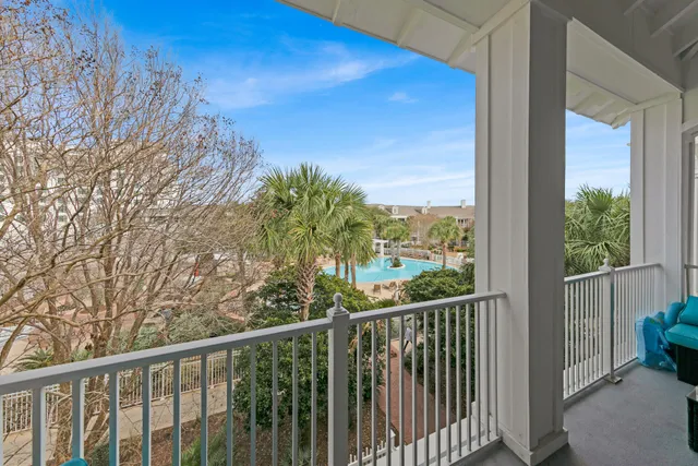a view of a balcony with wooden fence and floor