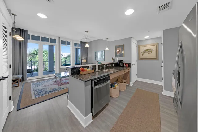 a kitchen with stainless steel appliances granite countertop a stove and a refrigerator