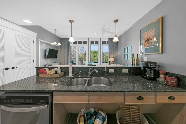 a kitchen with granite countertop a stove a sink and a granite counter tops