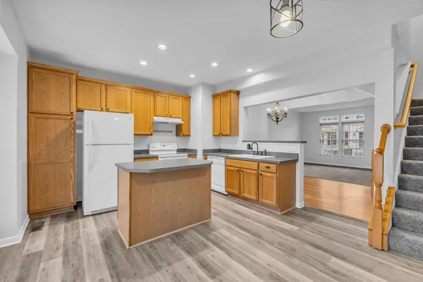 a kitchen with a sink a stove and cabinets