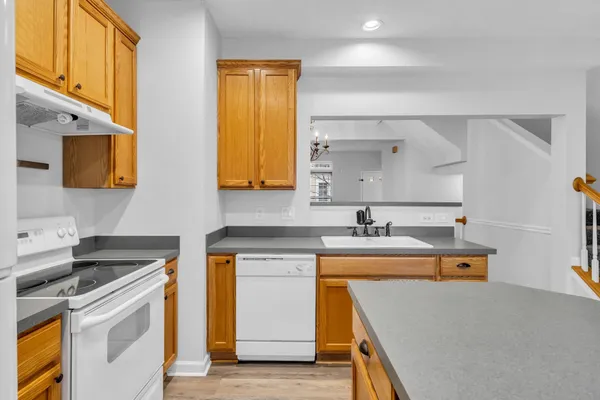 a kitchen with a sink a stove and refrigerator
