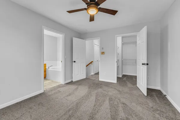 a bathroom with a granite countertop sink a toilet and shower
