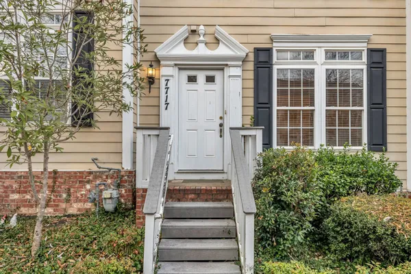 a view of a brick house with large windows