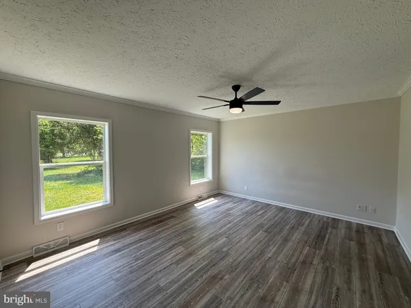 a view of a room with wooden floor