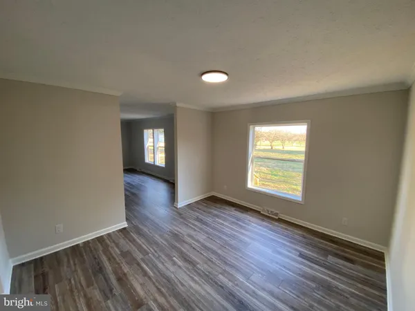 a view of an empty room and wooden floor