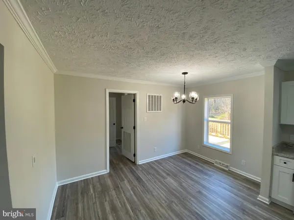 an empty room with wooden floor and closet