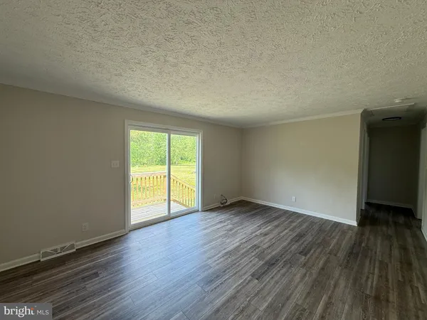 a white toilet sitting next to a white wall