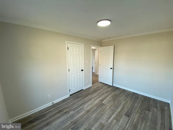 a view of a small space with wooden floor and a hallway