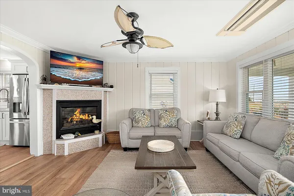 a living room with furniture a window and a chandelier