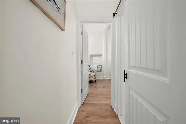 a spacious bedroom with a bed and a chandelier