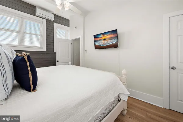 a bedroom with a large bed and a window