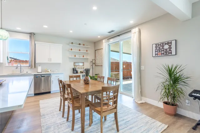 a dining room with furniture and wooden floor