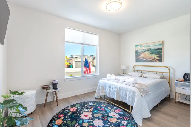 a bedroom with a bed and a lamp