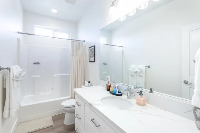 a bathroom with a sink toilet tub and shower